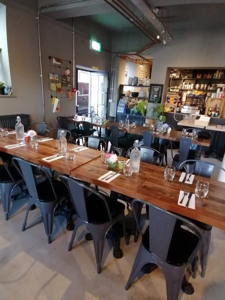 Tables laid up for a team meeting and lunch inside the EBIKE Cafe